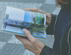 person holding a guidebook